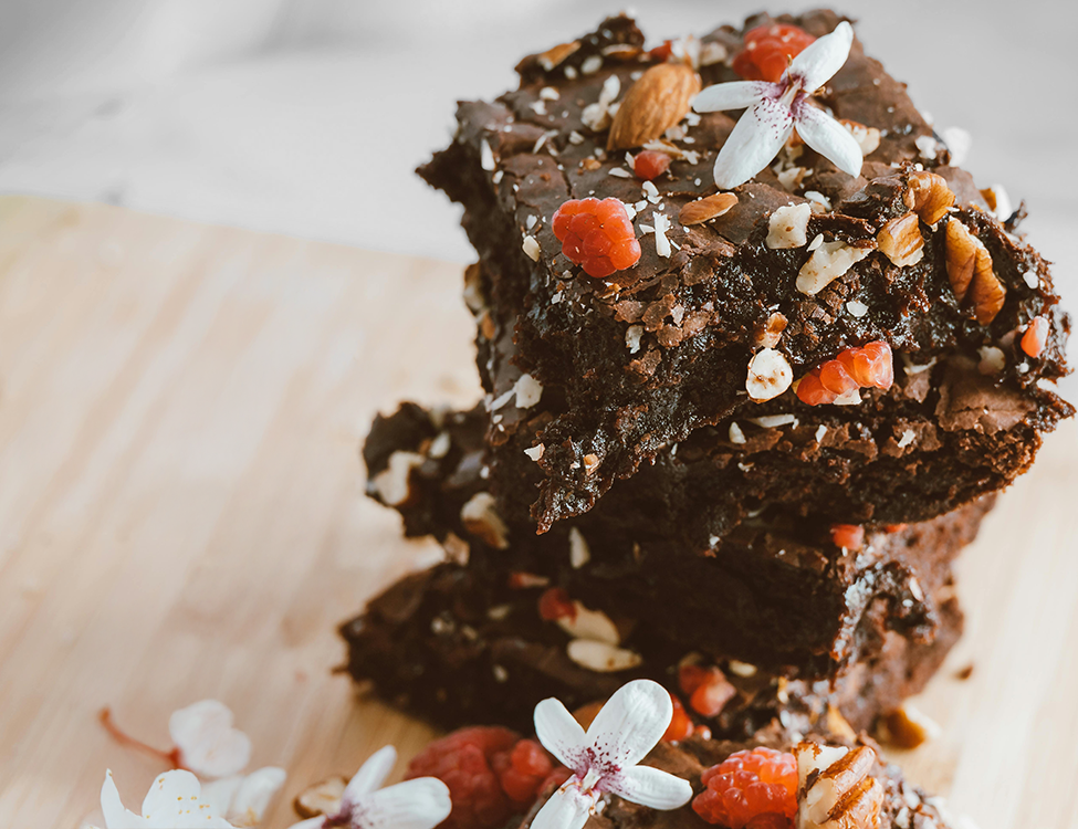brownie close up with nuts and berries on the top
