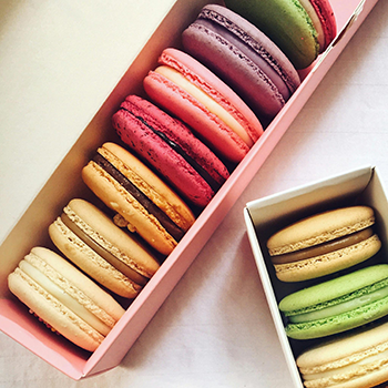 two boxes of different falvoured macarons